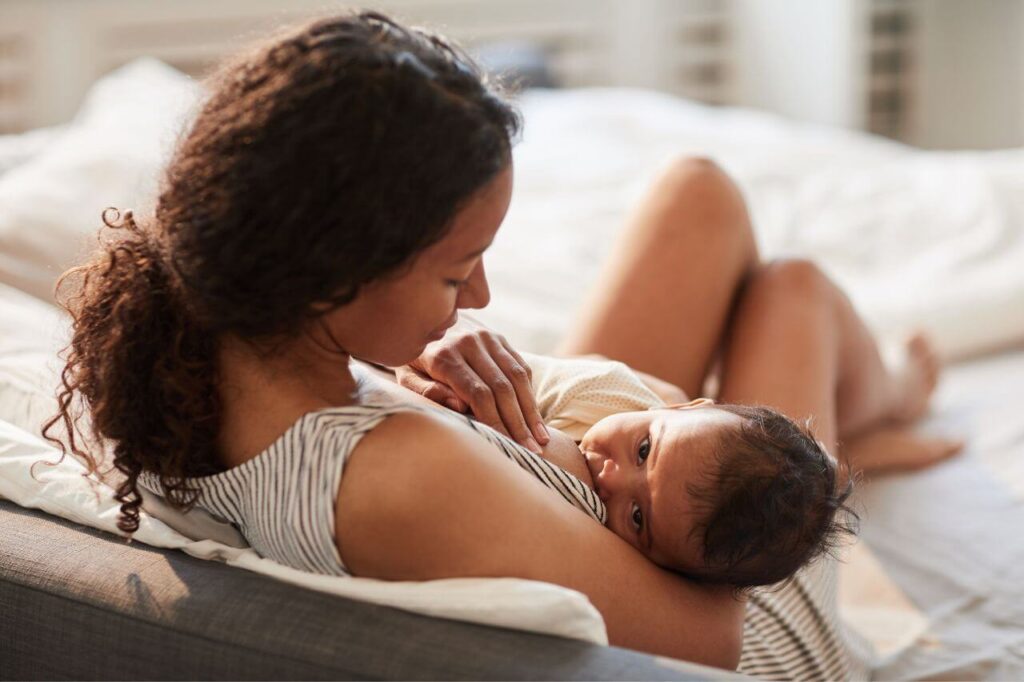 Young Mother Bresastfeeding Baby At Home