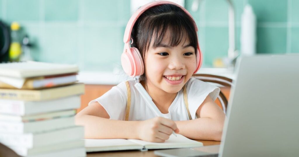 Child studying on laptop