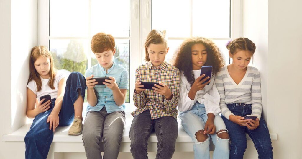 Children Using Mobile Instead Of Playing